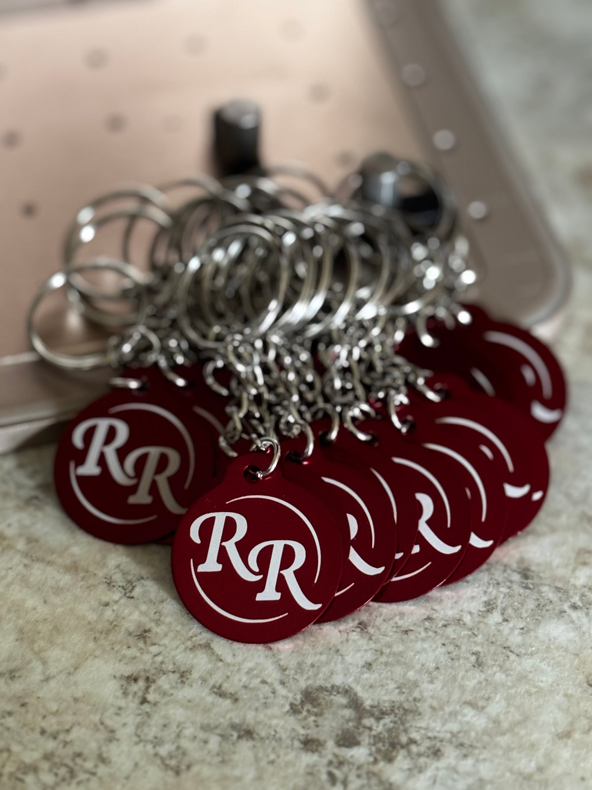 Custom set of red aluminum fleet vehicle identification key tags engraved with business logo and then job truck number on the back side.
