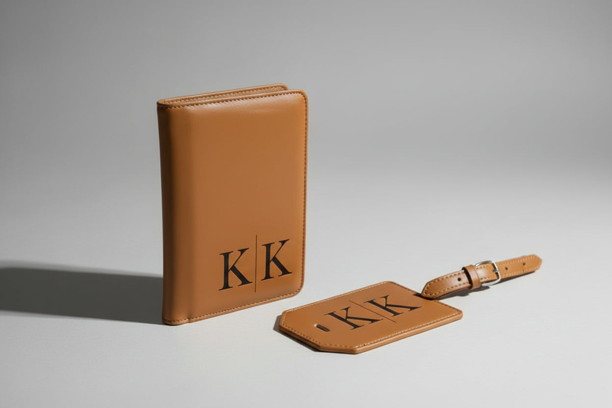 Two brown leather passport wallet and luggage tag with 'KK' monogram on a dark background