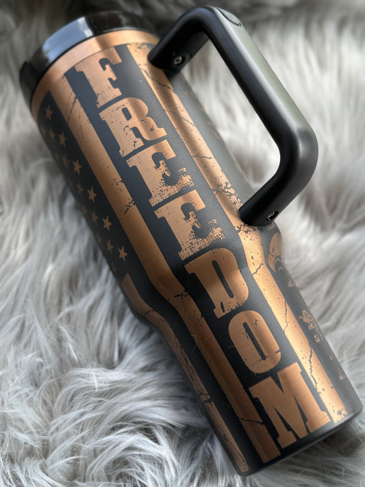 Tumbler engraved with We The People over a waving American flag
